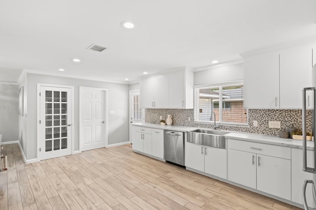 3619 N Braeswood Blvd, Houston, TX 77025 - kitchen with dishwasher, light countertops, ornamental molding, backsplash, and white cabinets