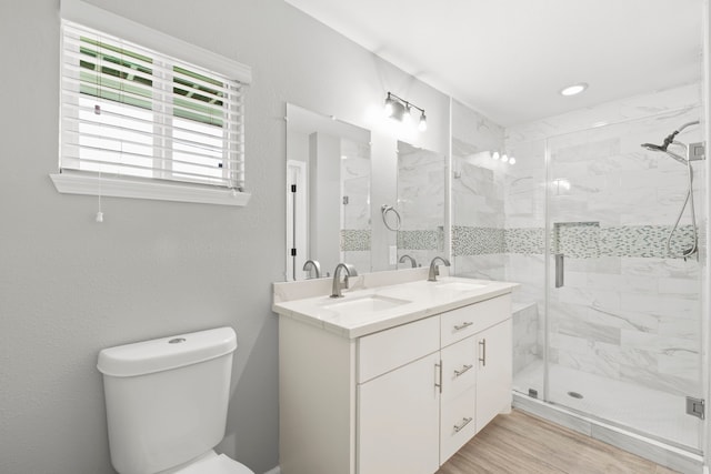 3619 N Braeswood Blvd, Houston, TX 77025 - bathroom featuring a stall shower, double vanity, and wood finished floors