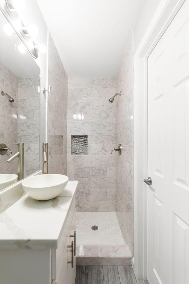 3619 N Braeswood Blvd, Houston, TX 77025 - full bathroom with vanity, wood finished floors, and a tile shower