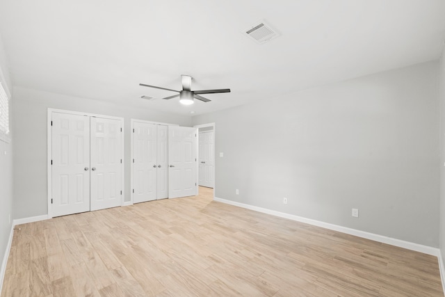 3619 N Braeswood Blvd, Houston, TX 77025 - unfurnished bedroom with multiple closets, light wood-style floors, and a ceiling fan
