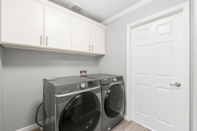 3619 N Braeswood Blvd, Houston, TX 77025 - laundry room featuring cabinet space, separate washer and dryer, ornamental molding, and light wood-style flooring