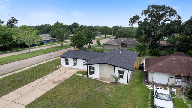 6155 Ridgeway Dr, Houston, TX 77033 - view of front facade featuring concrete driveway, a front yard, cooling unit, and a garage