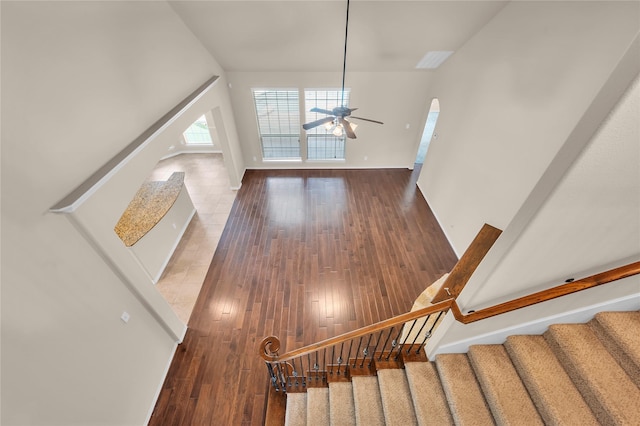 25402 Lancaster Pine Dr, Spring, TX 77389 - stairs with wood-type flooring, a ceiling fan, arched walkways, and baseboards