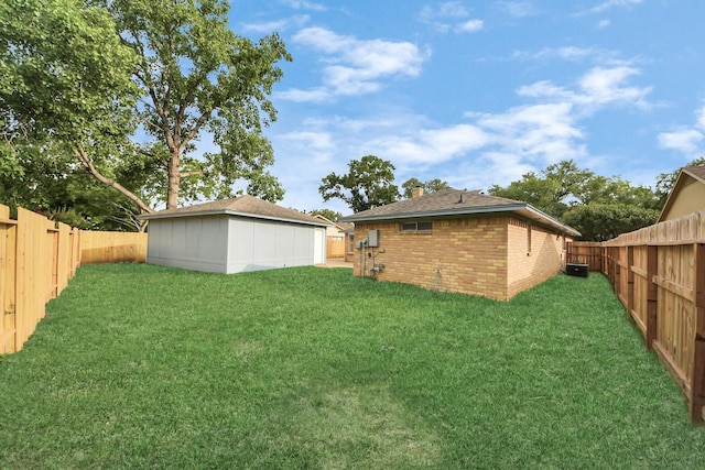 15723 Cascade Point Dr, Houston, TX 77084 - rear view of house with brick siding, a chimney, and an outbuilding
