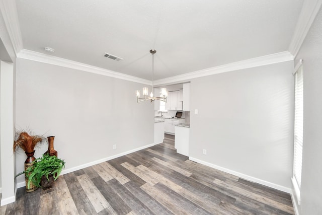 15723 Cascade Point Dr, Houston, TX 77084 - unfurnished dining area featuring a chandelier, crown molding, dark wood finished floors, baseboards, and plenty of natural light