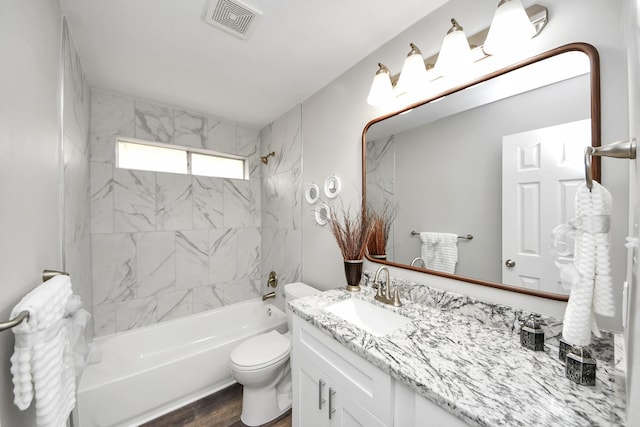 15723 Cascade Point Dr, Houston, TX 77084 - full bathroom with vanity, toilet,  shower combination, and wood finished floors