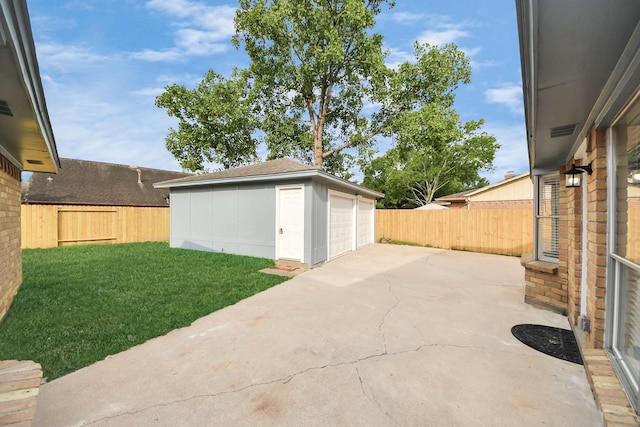 15723 Cascade Point Dr, Houston, TX 77084 - view of yard featuring a detached garage, an outbuilding, and a patio