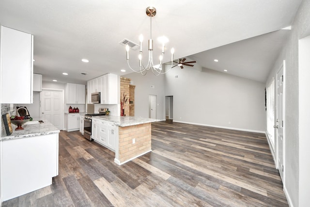 15723 Cascade Point Dr, Houston, TX 77084 - kitchen with appliances with stainless steel finishes, a sink, open floor plan, a chandelier, and white cabinetry