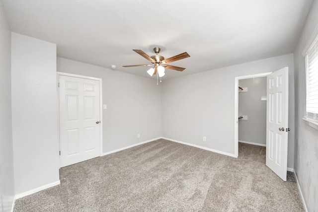 15723 Cascade Point Dr, Houston, TX 77084 - unfurnished bedroom with carpet floors, a walk in closet, baseboards, and ceiling fan