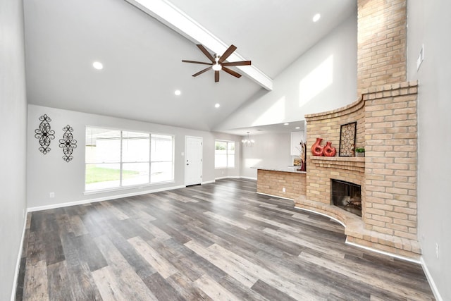 15723 Cascade Point Dr, Houston, TX 77084 - unfurnished living room with high vaulted ceiling, ceiling fan, beamed ceiling, a fireplace, and baseboards