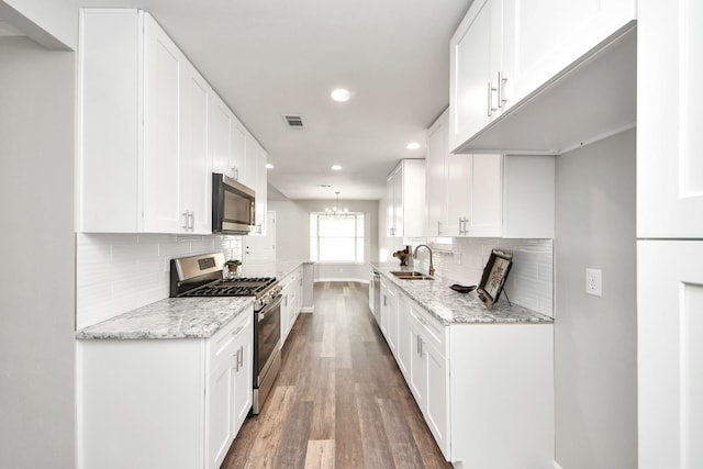 15723 Cascade Point Dr, Houston, TX 77084 - kitchen featuring appliances with stainless steel finishes, a sink, recessed lighting, baseboards, and tasteful backsplash