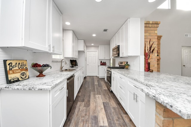 15723 Cascade Point Dr, Houston, TX 77084 - kitchen featuring stainless steel appliances, a sink, recessed lighting, white cabinetry, and light stone counters