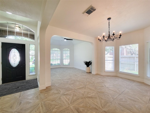 218 Windrift Ct, Sugar Land, TX 77479 - foyer featuring baseboards, arched walkways, a chandelier, and healthy amount of natural light