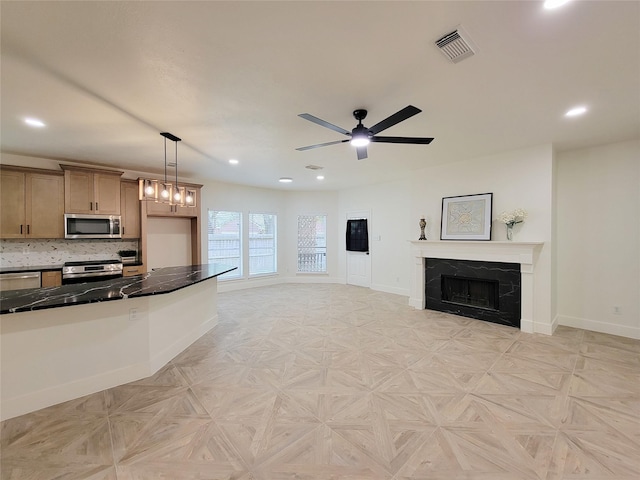 218 Windrift Ct, Sugar Land, TX 77479 - kitchen with stainless steel appliances, baseboards, dark countertops, open floor plan, and a fireplace