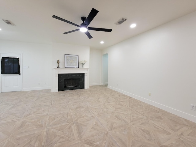 218 Windrift Ct, Sugar Land, TX 77479 - unfurnished living room with arched walkways, ceiling fan, baseboards, recessed lighting, and a fireplace