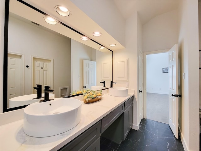 218 Windrift Ct, Sugar Land, TX 77479 - bathroom with marble look tile flooring, recessed lighting, double vanity, baseboards, and a towering ceiling