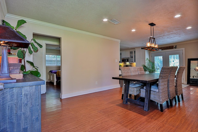 434 Lakeside Dr, Kemah, TX 77565 - dining area featuring ornamental molding, wood finished floors, recessed lighting, and a textured ceiling