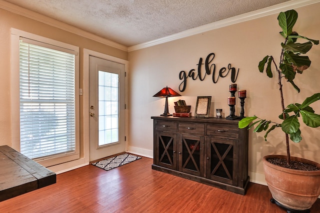 434 Lakeside Dr, Kemah, TX 77565 - doorway with a textured ceiling, dark wood-style floors, and ornamental molding