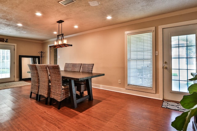 434 Lakeside Dr, Kemah, TX 77565 - dining space featuring dark wood-style floors, crown molding, healthy amount of natural light, a textured ceiling, and recessed lighting