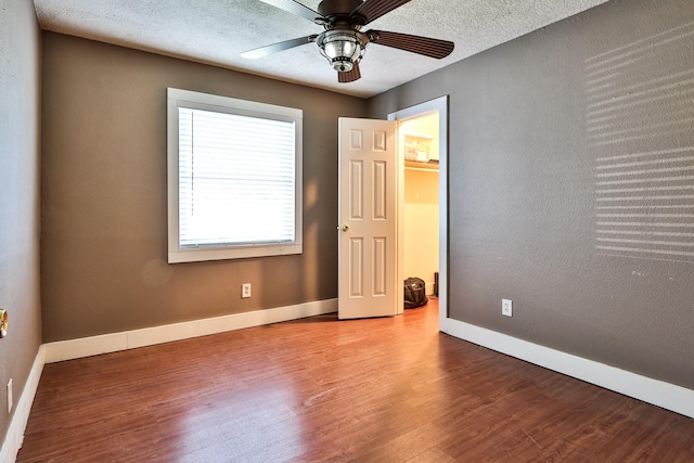 434 Lakeside Dr, Kemah, TX 77565 - unfurnished bedroom featuring wood finished floors, ceiling fan, and a textured ceiling