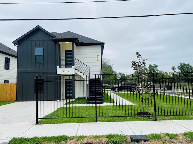 3107 Grassmere St A/B, Unit A/B Houston, TX 77051 - view of front of house with board and batten siding, stairway, and roof with shingles