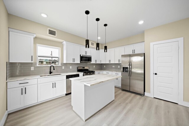 3107 Grassmere St A/B, Unit A/B Houston, TX 77051 - kitchen with stainless steel appliances, a sink, light wood-type flooring, decorative backsplash, and recessed lighting