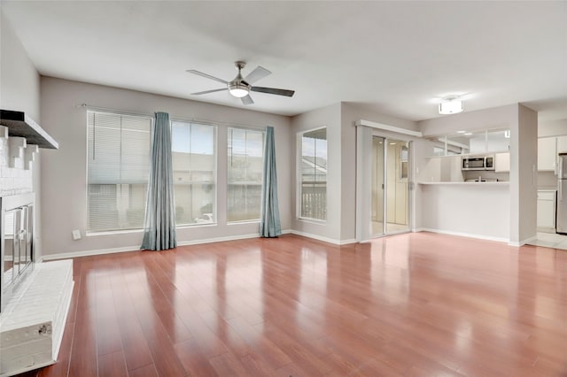 1500 Bay Area Blvd Unit 433, Houston, TX 77058 - unfurnished living room featuring a ceiling fan, wood finished floors, and baseboards