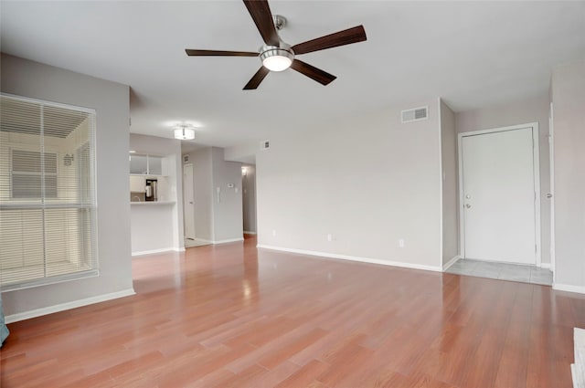 1500 Bay Area Blvd Unit 433, Houston, TX 77058 - unfurnished living room featuring a ceiling fan, light wood-type flooring, and baseboards