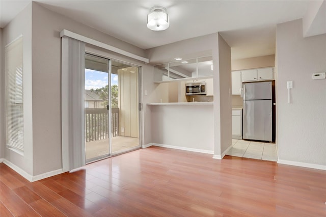 1500 Bay Area Blvd Unit 433, Houston, TX 77058 - unfurnished dining area with light wood-style flooring and baseboards