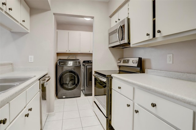 1500 Bay Area Blvd Unit 433, Houston, TX 77058 - laundry room featuring washing machine and dryer and light tile patterned floors