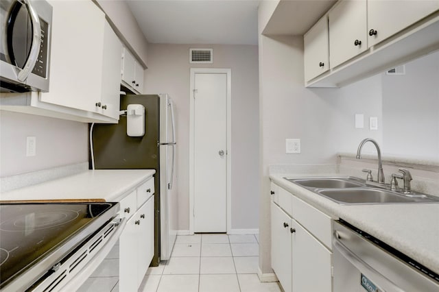 1500 Bay Area Blvd Unit 433, Houston, TX 77058 - kitchen with stainless steel appliances, a sink, light tile patterned flooring, light countertops, and white cabinetry