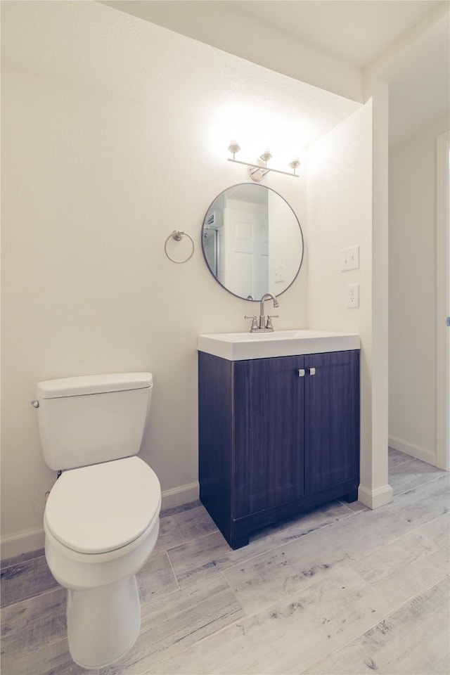 12553 Wellington Park Dr, Houston, TX 77072 - bathroom featuring toilet, vanity, baseboards, and wood finished floors