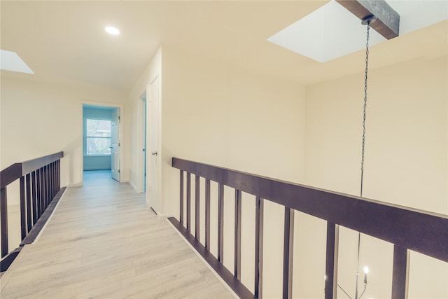 12553 Wellington Park Dr, Houston, TX 77072 - hallway featuring a skylight, light wood-style flooring, recessed lighting, and baseboards