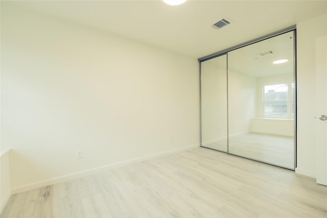 12553 Wellington Park Dr, Houston, TX 77072 - unfurnished bedroom featuring light wood-style floors, a closet, and baseboards