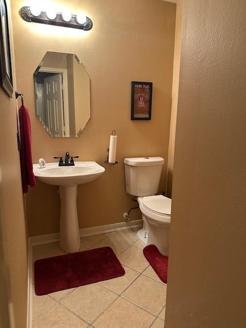 14602 Harcourt Bridge Ct, Houston, TX 77084 - half bathroom featuring tile patterned floors, toilet, and baseboards
