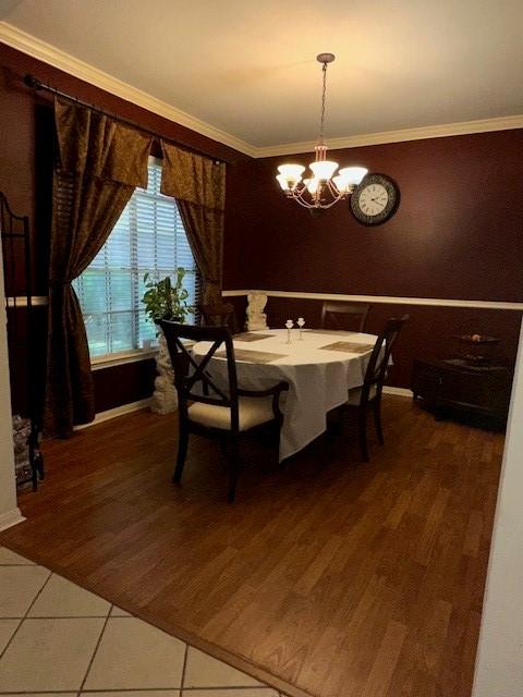 14602 Harcourt Bridge Ct, Houston, TX 77084 - dining room featuring a chandelier, ornamental molding, light tile patterned floors, and baseboards