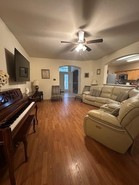 14602 Harcourt Bridge Ct, Houston, TX 77084 - living area with arched walkways, wood finished floors, and a ceiling fan