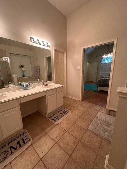 14602 Harcourt Bridge Ct, Houston, TX 77084 - ensuite bathroom with double vanity, high vaulted ceiling, tile patterned flooring, baseboards, and ceiling fan