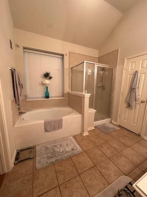 14602 Harcourt Bridge Ct, Houston, TX 77084 - bathroom with a stall shower, a bath, tile patterned floors, and vaulted ceiling