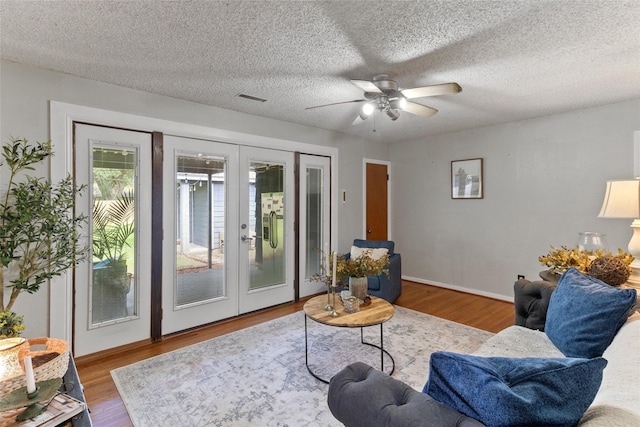 315 Cypress St, Lake Jackson, TX 77566 - living room featuring french doors, wood finished floors, ceiling fan, and a textured ceiling