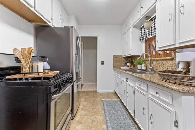 315 Cypress St, Lake Jackson, TX 77566 - kitchen with a sink, stainless steel gas range, decorative backsplash, and white cabinets
