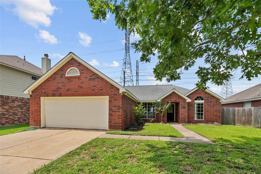 4214 Custer Creek Dr, Missouri City, TX 77459 - view of front of house featuring a garage, driveway, and brick siding