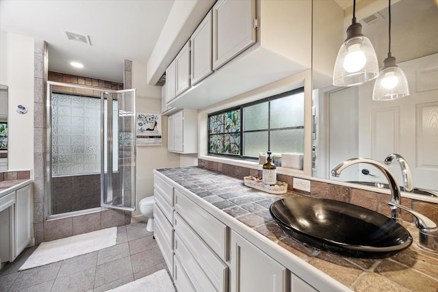 14111 Decker Dr, Magnolia, TX 77355 - full bathroom with vanity, a stall shower, toilet, and tile patterned flooring