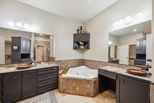 14111 Decker Dr, Magnolia, TX 77355 - bathroom featuring two vanities, a whirlpool tub, a stall shower, and tile patterned flooring
