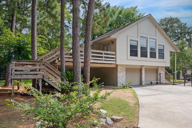 14111 Decker Dr, Magnolia, TX 77355 - view of front of house featuring stairway, a garage, stone siding, and driveway