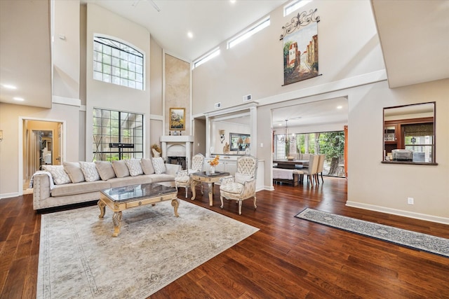 14111 Decker Dr, Magnolia, TX 77355 - living area with baseboards, a fireplace, a towering ceiling, wood finished floors, and recessed lighting