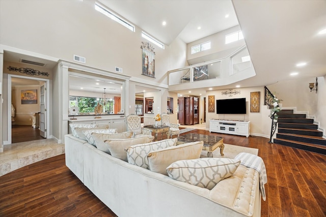 14111 Decker Dr, Magnolia, TX 77355 - living room with healthy amount of natural light, stairway, dark wood finished floors, a high ceiling, and baseboards