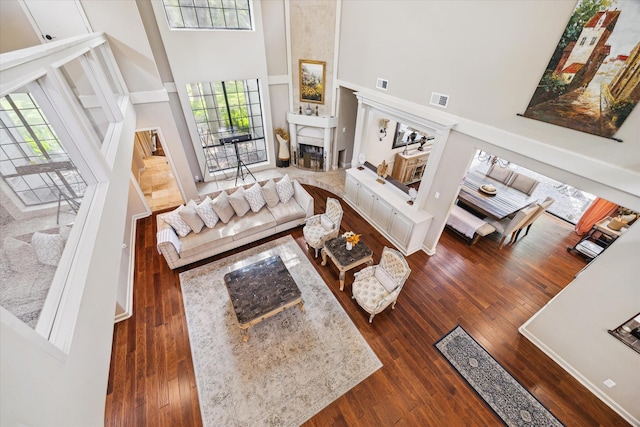14111 Decker Dr, Magnolia, TX 77355 - living room with a towering ceiling, wood-type flooring, and a fireplace with raised hearth