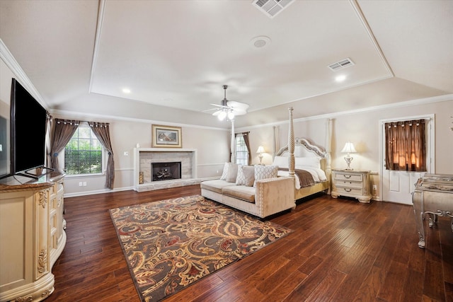 14111 Decker Dr, Magnolia, TX 77355 - bedroom featuring dark wood finished floors, a stone fireplace, baseboards, and ceiling fan