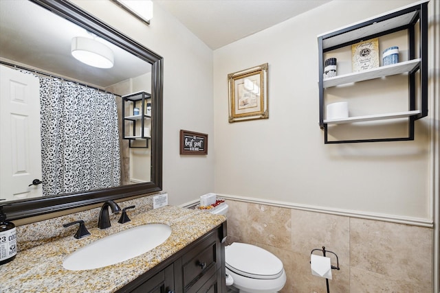 14111 Decker Dr, Magnolia, TX 77355 - full bath featuring tile walls, toilet, vanity, wainscoting, and a shower with shower curtain